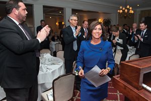 About 180 Lake County Bar Association members and guests applaud 2nd District Appellate Justice Mary Seminara Schostok as she walks to the podium to receive the group ’s Humanitarian Award at the LCBA President’s Award Dinner in Highland Park. Schostok was honored for her work with the Michael Matters Foundation, which honors the memory of her husband, attorney Michael P. Schostok, who died from brain cancer in 2012 at age 51. The foundation works to increase the public’s awareness of glioblastoma brain tumors and provides financial assistance to families dealing with the disease. 