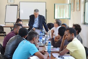 Richard Chesley, a partner at DLA Piper in Chicago, works with Ethiopian lawyers and law students at the Addis Ababa University College of Law and Governance Studies in the nation’s capital during a training course on complex business negotiations. 