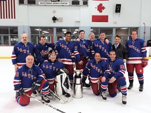 The Masters Hockey League of Chicago championship team, the Lawyers, gather after their victory. (Front from left) Steve Demitro; Tom Paprocki, bishop of Springfield; Mike Goldberg; Ron Kalish. (Back from left) David Goldman; U.S. Rep. Mike Quigley; Ravi Baichwal, WLS-TV Channel 7 anchor-reporter; Ryan Chiaverini, “Windy City Live” television host; John Muldoon; Nick Labun; Kent Sinson; and David Vander Ploeg.