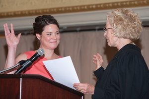 Illinois Supreme Court Justice Anne M. Burke administers the oath of office to incoming Women's Bar Association of Illinois President Michelle M. Kohut at the group's 99th annual installation dinner. About 700 people attended. Kohut is an associate at Corboy & Demetrio.