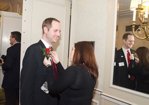 Michael J. Zink, partner at Starr Bejgiert Zink & Rowells, gets some help with his boutonniere prior to the Advocates Society’s 83rd annual installation of officers and awards dinner at the Drake Hotel. Zink was sworn in as the bar group’s first vice president. 