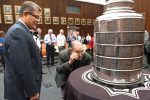 Chief U.S. District Judge Ruben Castillo and his father, Ruben N. Castillo, examine the Stanley Cup in the Parsons Ceremonial Courtroom at the Dirksen Federal Courthouse. The NHL championship trophy, won by the Chicago Blackhawks in June, made a two-hour unpublicized visit to the court. 