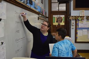 Julia A. Derish, associate at Skadden, Arps, Slate, Meagher & Flom, works with a student at O.A. Thorp Scholastic Academy on the city’s Northwest Side through the Constitutional Rights Foundation Chicago’s Lawyers in the Classroom program. 