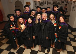 Justice David A. Erickson, Director of the Trial Advocacy Program and Co-Director of the Program in Criminal Litigation at Chicago-Kent College of Law, poses for a photo with graduating students at commencement on May 19 at the Chicago Theatre.