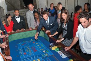 All eyes are on the dice as Jonathan Mraunac tries his luck at the craps table during the seventh annual Casino Legale at the Chicago Cultural Center. Mraunac is of counsel at Ogletree Deakins Nash Smoak & Stewart. Flanking Mraunac are Kenya Jenkins-Wright (left), an associate at Greene and Letts, and Jessica L. Bednarz (right), program manager for The Chicago Bar Foundation. Casino Legale is hosted by the CBF Young Professionals Board and The Chicago Bar Association Young Lawyers Section. 
