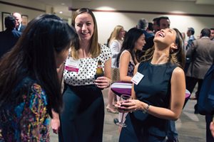 Loyola University Chicago School of Law 2009 graduates Tiffany Gehrke of Marshall Gerstein & Borun (center) and Anna Barreiro Sutti of Jenner & Block (right) share a laugh with professor Cynthia Ho during the 2014 Law Reunion at the Philip H. Corboy Law Center. 
