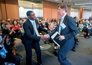 University of Illinois senior Fuad Akinbiyi (left) shakes the hand of Winston & Strawn ’s Steve J. Gavin after Gavin received the Making A Difference Award during Lawyers Lend-A-Hand to Youth’s My Hero Awards ceremony. Akinbiyi was one of the students helped by the program. 