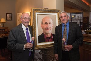 The board of the Lawyers for the Creative Arts honored Bill Rattner (left), its longest-serving executive director, and presented him with a portrait by Jenny Guo. The board also gave him and Jan Feldman, the incoming executive director, bobbleheads of Rattner.