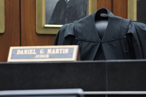 On Dec. 11, the U.S. District Court for the Northern District of Illinois celebrated the late U.S. District Judge Daniel G. Martin, who passed away Oct. 11, at a memorial in the Ceremonial Courtroom where his colleagues on the federal magistrate bench left an empty seat with Martin’s robe and his name plate. 