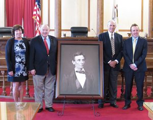 The 3rd District Appellate Court received a reproduced 1860 portrait of Abraham Lincoln in July in a ceremony at the Ottawa courthouse, across the street from the site of the first Lincoln-Douglas debate in August 1858. The image is owned by the Illinois State Historical Society, which seeks to place a copy in every Illinois county courthouses to commemorate the state’s bicentennial year. The 3rd District is the first of the appellate courts to receive the portrait. Appellate Justice William E. Holdridge, the great-great-grandson of a Lincoln client, donated the portrait, according to an announcement from Holdridge’s staff. Pictured (left to right) are 3rd District Appellate  Clerk Barbara Trumbo, Justices Robert L. Carter and Holdridge and court research director Matthew G. Butler. 