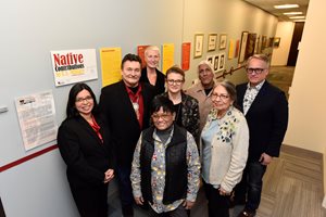 Larry Eppley, far right, the managing partner of Sheppard Mullin’s Chicago office, and the firm’s office administrator Betsy Zukley, middle back, pose with Trickster Art Gallery employees and Native American war veterans during a Dec. 17 reception celebrating Sheppard Mullin’s latest art installation in collaboration with Trickster: a 40-foot-long timeline chronicling the involvement of Native Americans in the U.S. military from the Revolutionary War through today. This latest exhibit is part of the Sheppard Mullin’s Art for the Sake of Community Program, in which the Chicago office works with and supports various art initiatives affiliated with city civic groups, charities and schools.